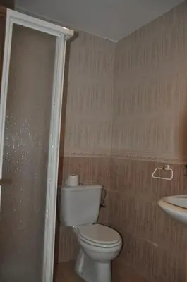 a bathroom with a toilet and a sink at Casa Polín in Las Herrerías