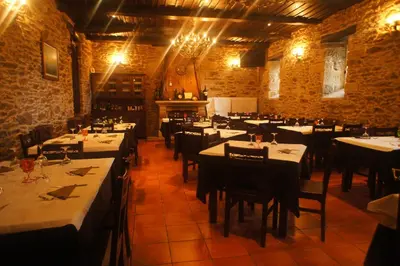 a restaurant with tables and chairs in a room at Mirador Da Ribeira in Viana do Bolo
