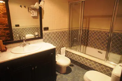 a bathroom with a sink and a toilet and a shower at Mirador Da Ribeira in Viana do Bolo