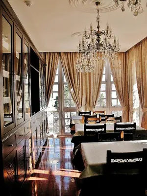 a dining room with a chandelier and tables and chairs at Mirador Da Ribeira in Viana do Bolo