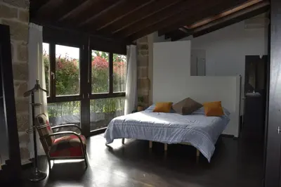 a bedroom with a bed and a large window at Ribeira sacra ourense in Ourense