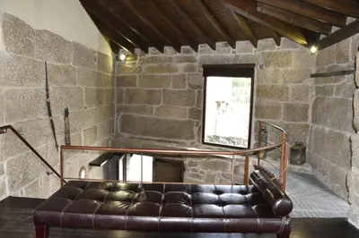 a leather couch in a room with a brick wall at Ribeira sacra ourense in Ourense