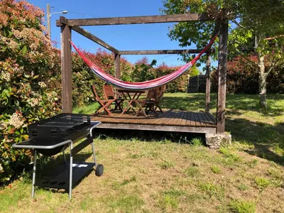 a hammock and a grill on a wooden deck at Ribeira sacra ourense in Ourense