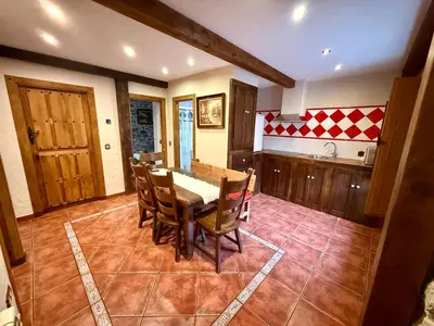 a kitchen with a dining room table and chairs at Casa Rural Bango in Caboalles de Abajo