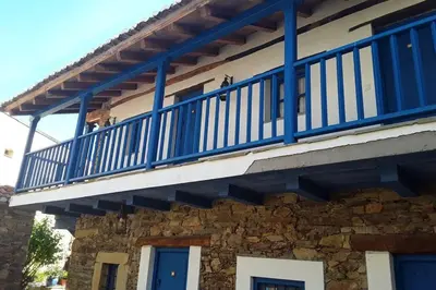 a blue balcony on the side of a building at CASA CAMARGA in Santiago Millas