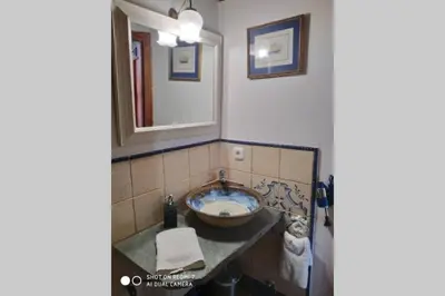 a bathroom with a sink and a mirror at CASA CAMARGA in Santiago Millas