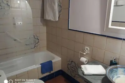 a bathroom with a bath tub and a sink at CASA CAMARGA in Santiago Millas