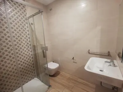 a bathroom with a shower and a toilet and a sink at Lar do Peregrino in Palas de Rei