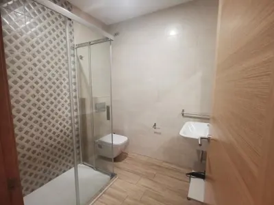 a bathroom with a shower and a toilet and a sink at Lar do Peregrino in Palas de Rei