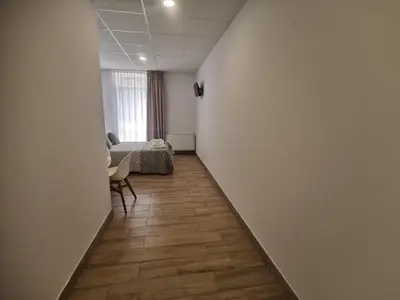a hallway with a room with a bed and a table at Lar do Peregrino in Palas de Rei