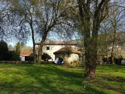a building with a tent in a field with trees at CAPELA DA GRANXA in Pontevedra