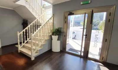 a staircase in a house with a glass door at Hotel Prados in Lugo