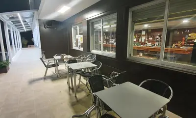 a dining room with tables and chairs in a restaurant at Hotel Prados in Lugo