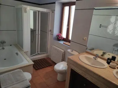 a bathroom with a tub and a sink and a toilet at Casa Camino Santiago-Fisterra in Amés