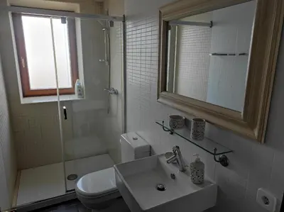 a bathroom with a toilet and a sink and a shower at Casa Camino Santiago-Fisterra in Amés