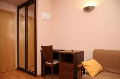 a room with a desk and a chair and a table at Hotel Restaurante Casa Pipo in Tuña