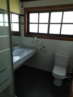 a bathroom with a toilet and a sink and a window at Camiño da Vieira in Padrón