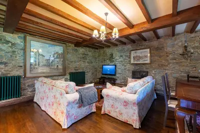 a living room with two couches and a tv at Villa en Asturias con cine, Piscina, BBQ, Juegos, 14 Pax in Cobre