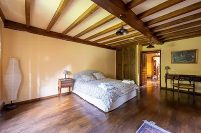 a bedroom with a bed and a wooden ceiling at Villa en Asturias con cine, Piscina, BBQ, Juegos, 14 Pax in Cobre