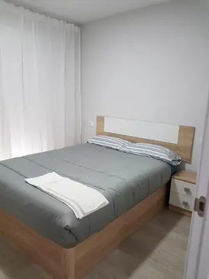 a bedroom with a bed with a wooden frame at A casa de Mateo in Ribadavia