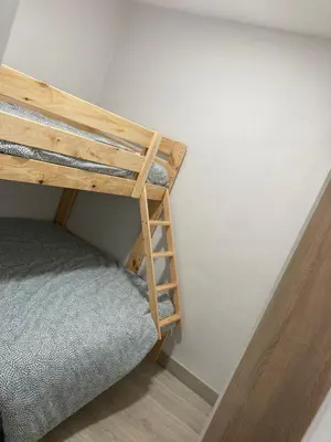 a bunk bed in a room with a ladder at A casa de Mateo in Ribadavia