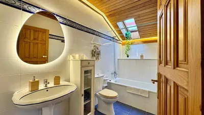 a bathroom with a sink and a toilet and a tub at Apartamentos rurales La Pornacal I y La Pornacal II in Villar de Vildas