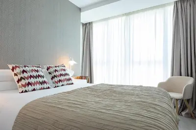 a bedroom with a large bed and a large window at CONCHEIROS 5 APARTAMENTOS TURISTICOS in Santiago de Compostela