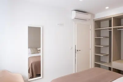 a bedroom with a mirror and a bed at CONCHEIROS 5 APARTAMENTOS TURISTICOS in Santiago de Compostela