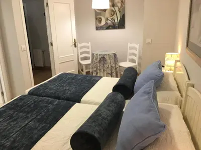 a bedroom with two beds with black and white sheets at Hostal Restaurante Alarico in Allariz