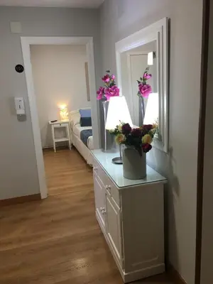 a room with a bed and a dresser with flowers on it at Hostal Restaurante Alarico in Allariz
