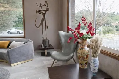 a living room with a vase of flowers on a table at Hotel San Rosendo in Ourense