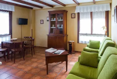 a living room with a couch and a table at As Tapias Apartamentos in Tapia de Casariego