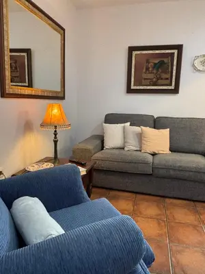 a living room with two couches and a lamp at As Tapias Apartamentos in Tapia de Casariego