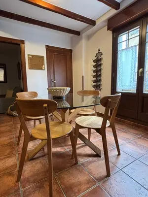 a dining room with a table and chairs at As Tapias Apartamentos in Tapia de Casariego