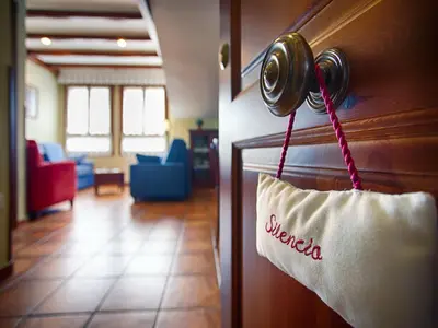 a hotel room door with a welcome sign on it at As Tapias Apartamentos in Tapia de Casariego