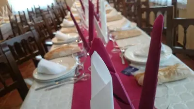 a long table with plates of food and napkins on it at Casa Poy in Becerreá