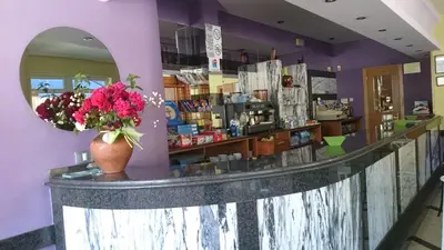 a counter in a store with a vase of flowers at Casa Poy in Becerreá