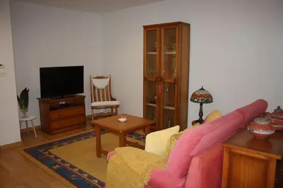 a living room with a couch and a tv at Casa Galipendre in A Estrada