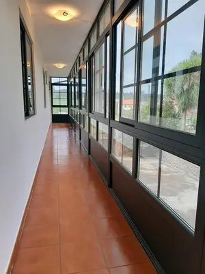 a hallway with windows and a tiled floor at Casa Galipendre in A Estrada