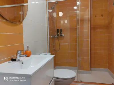 a bathroom with a shower and a toilet and a sink at AURINE in Foz