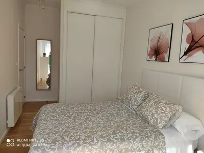 a bedroom with a bed and two pictures on the wall at AURINE in Foz