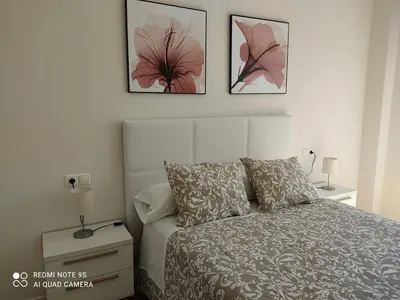 a bedroom with a bed and three pictures on the wall at AURINE in Foz