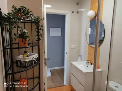 a bathroom with a sink and a mirror at AURINE in Foz