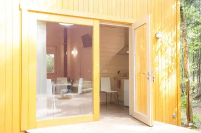 an open sliding glass door of a house at Cabanas da Ulla in Touro