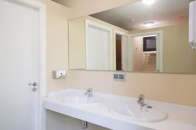 a bathroom with two sinks and a mirror at Cabanas da Ulla in Touro