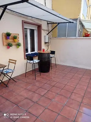 a patio with chairs and a table and awning at PISO BENITO in Ourense