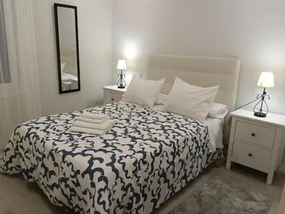 a bedroom with a bed with a black and white comforter at PISO BENITO in Ourense