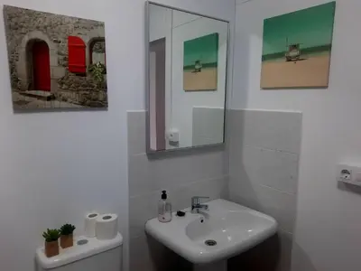 a white bathroom with a sink and a mirror at Casa Manola in Teo