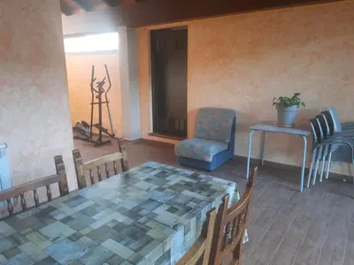 a living room with a table and a chair at Casa Manola in Teo