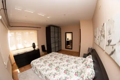 a bedroom with a large bed and a window at HOLIDAY HOMES Figueras AT in Castropol